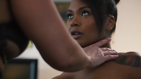 Milf licks the pussy of a black girl before using a strap-on